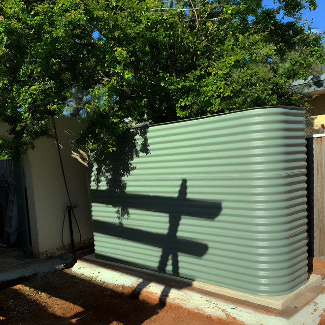 colorbond pale eucalypt water tank on a concrete pad