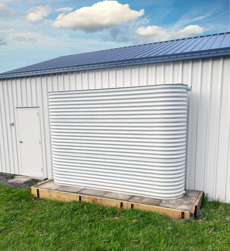 Surfmist slimline tank on a nice pad sitting in front of a matching shed