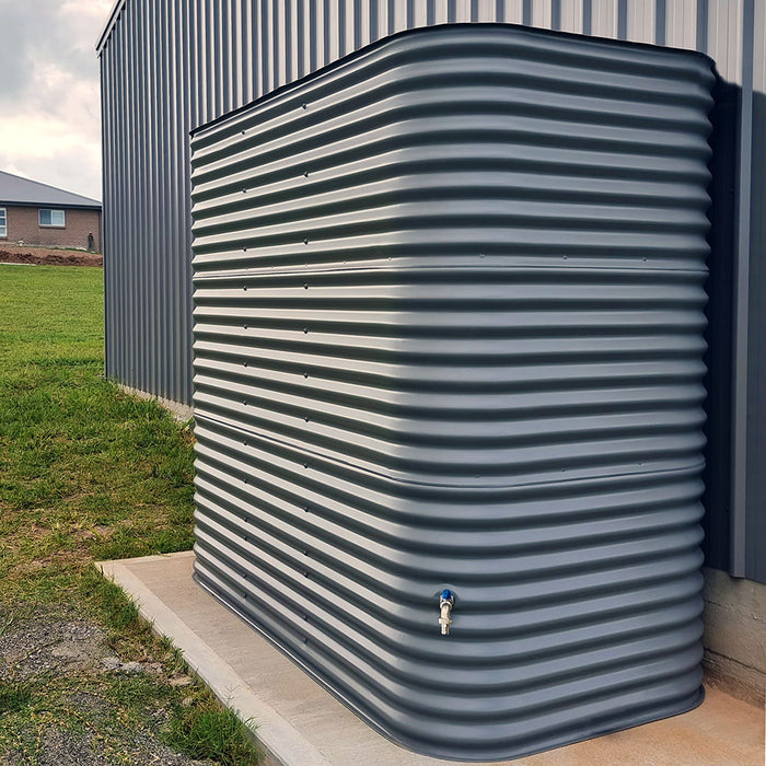 A modline or square water tank sitting on a concrete pad behind a shed