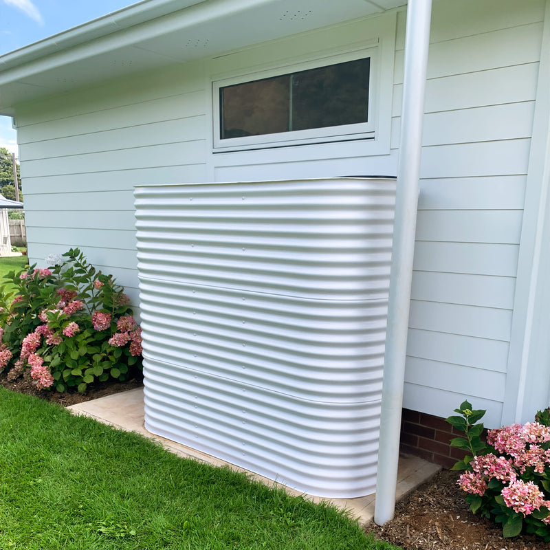 A surfmist steel water tank in a cottage garden