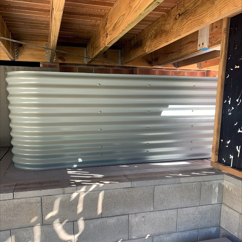 a custom short steel water tank under a deck